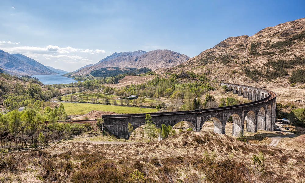 Famous Glenfinnan Railway Viaduct with beautiful countryside in Scotland, UK